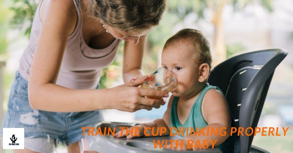 A baby drinking from an open cup