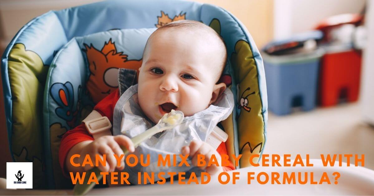 Cute baby eating cereal with a spoon