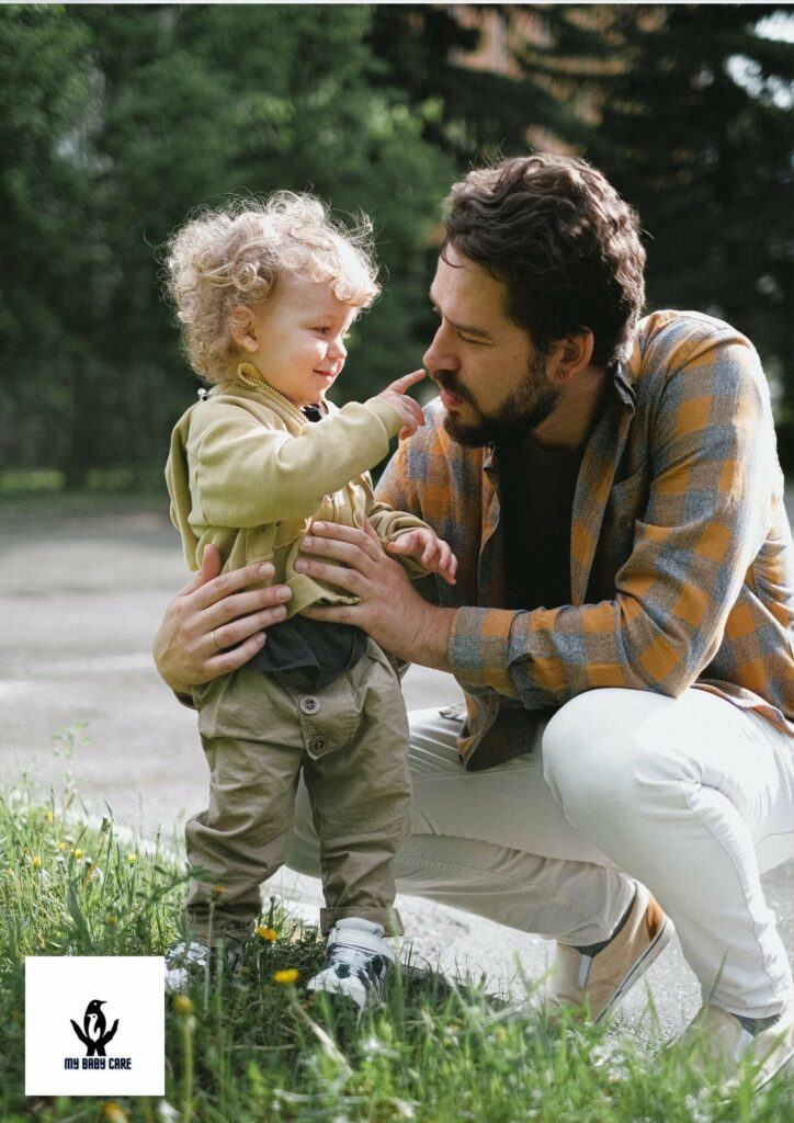 cute baby pinching his father's nose