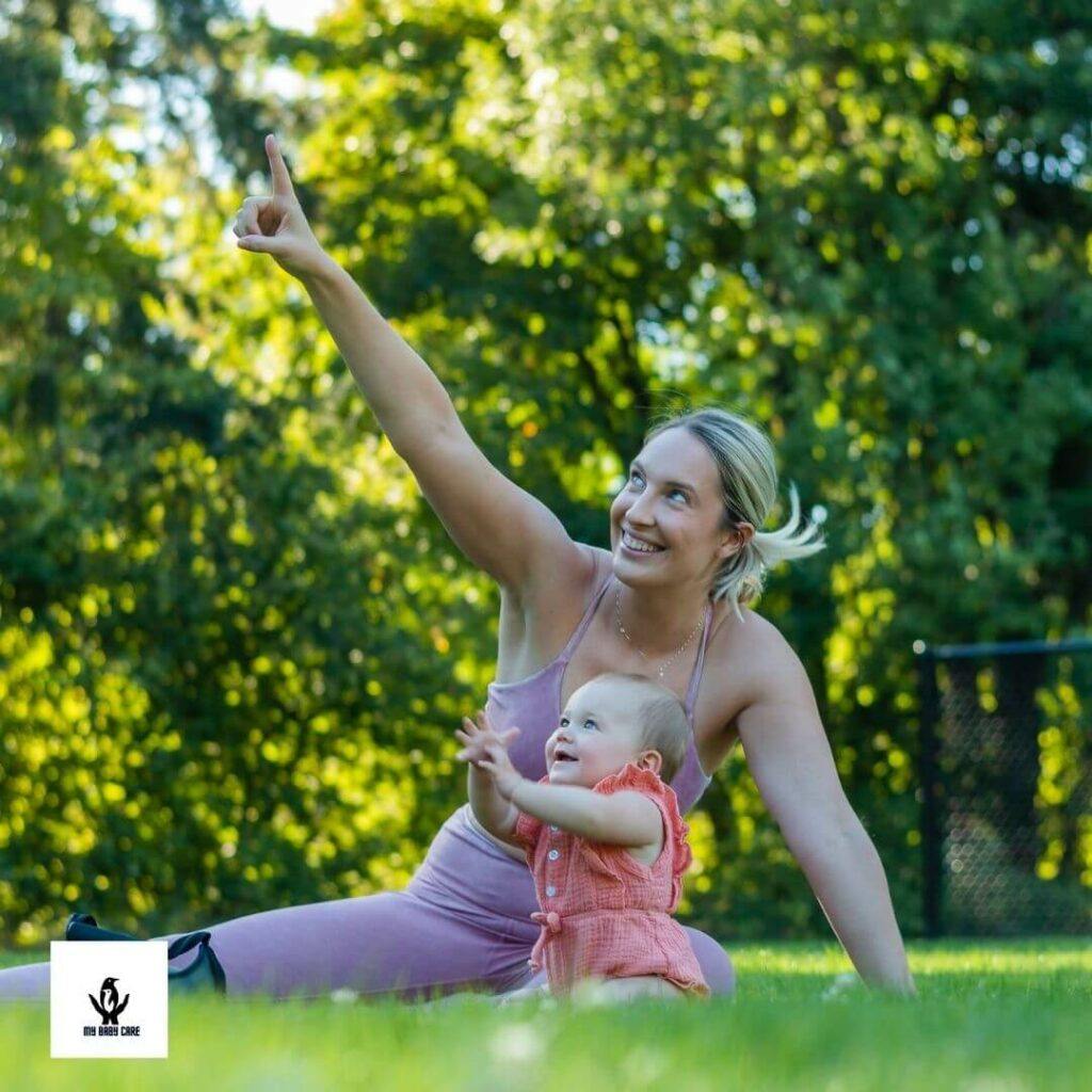 Adorable mom points something in sky towards a beautiful baby