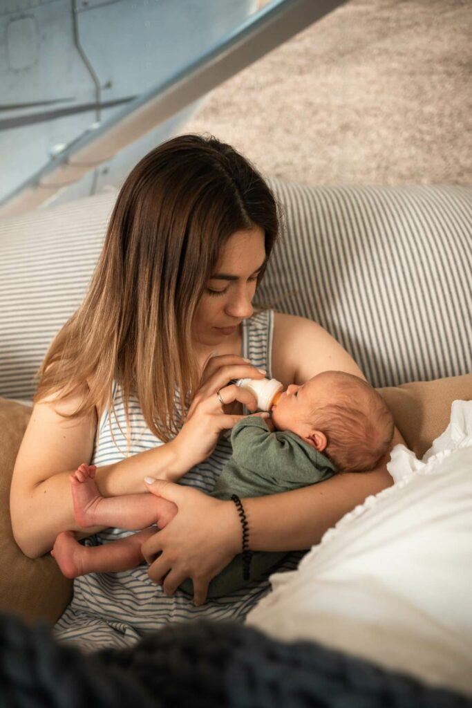 Beautiful mom feeds baby