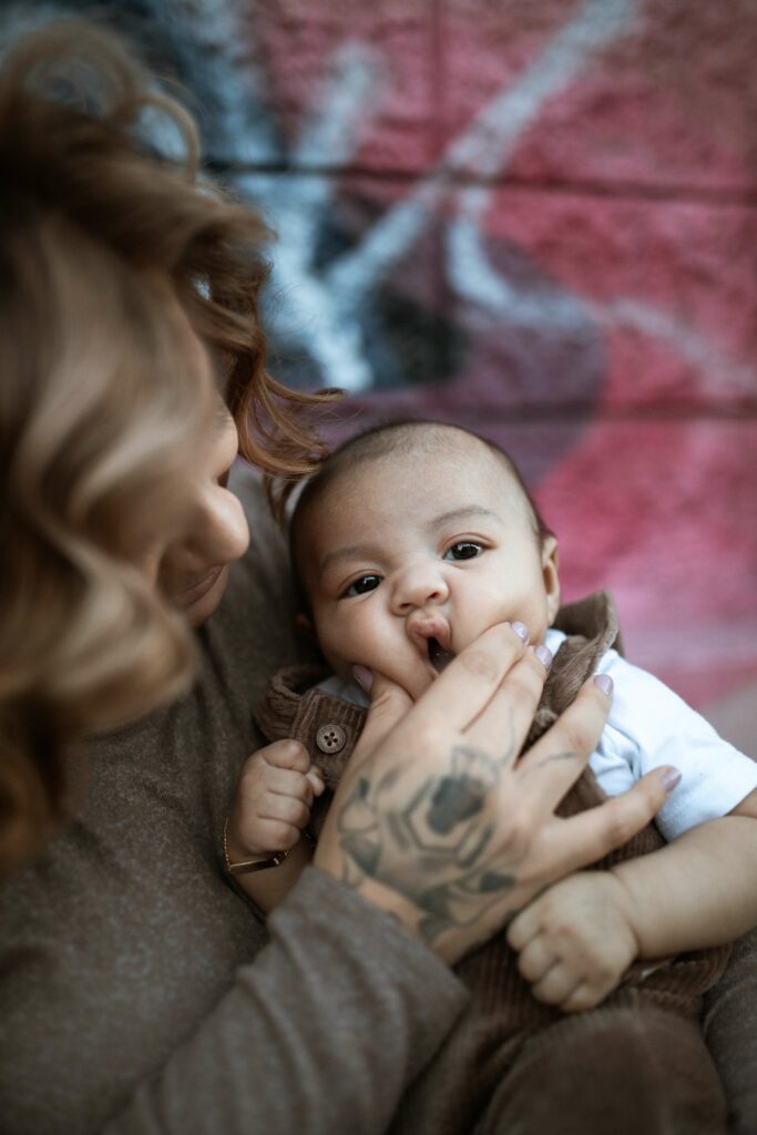 mom touches the baby's crunched face