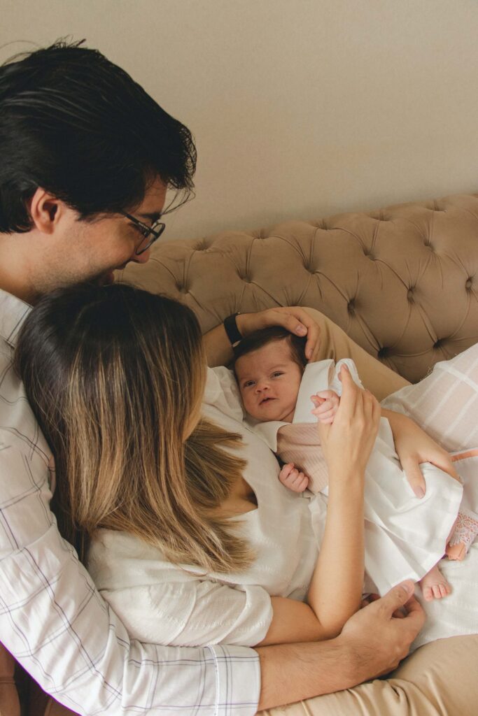 Mother and father cuddle the adorable baby