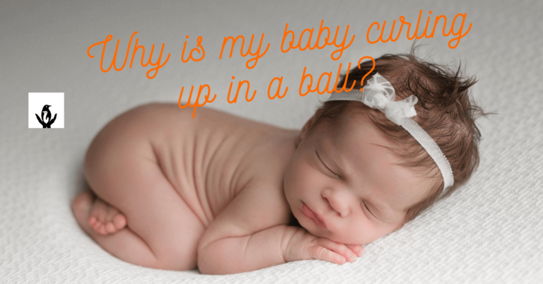 adorable baby is curling up on a mat