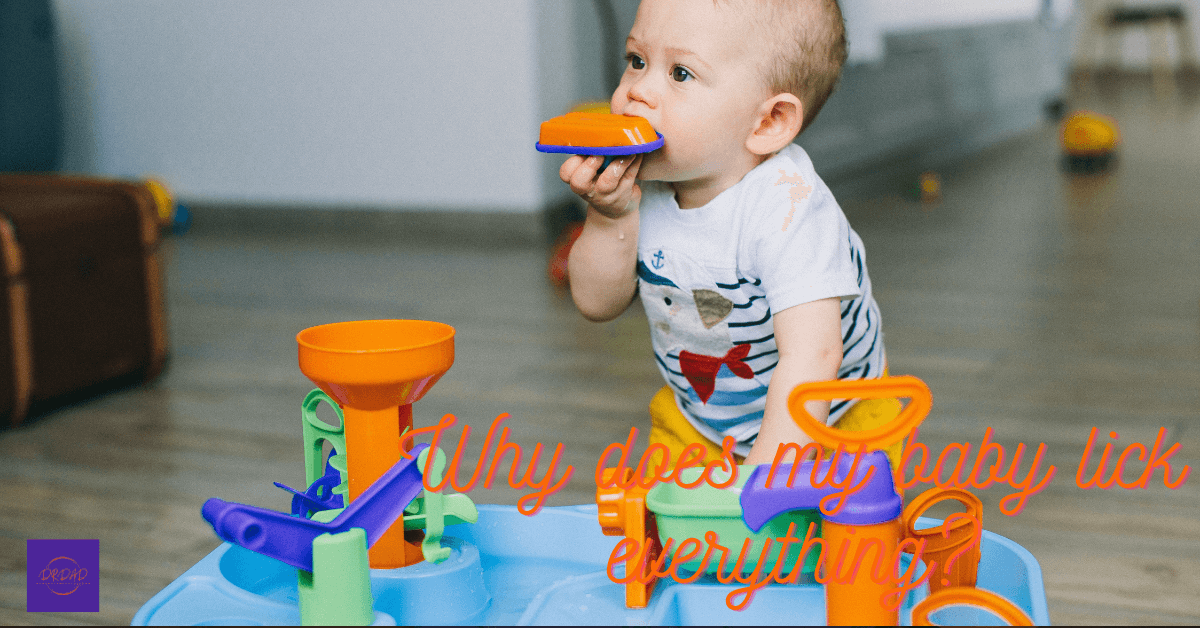 cute baby licks his toys